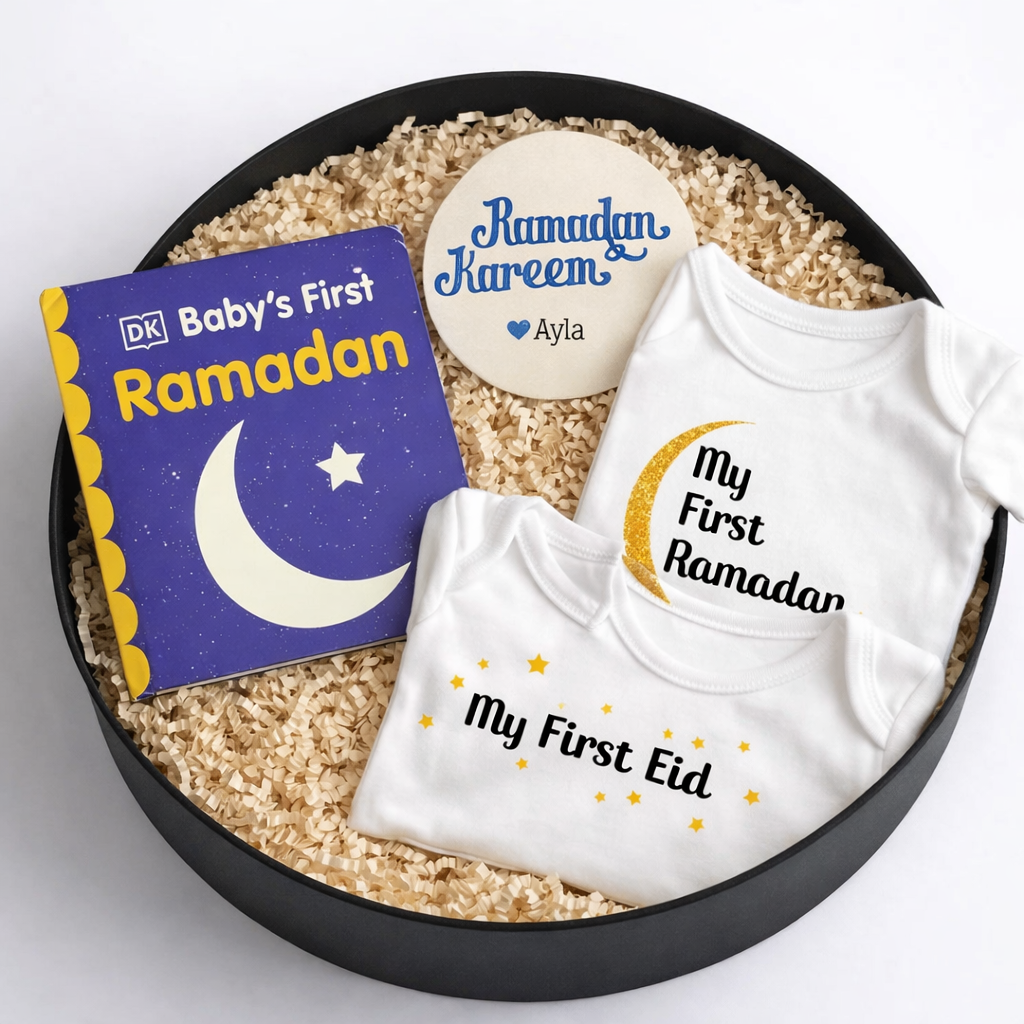 Baby's First Ramadan gift set with a book, bodysuits, and a keepsake disc in a black box.