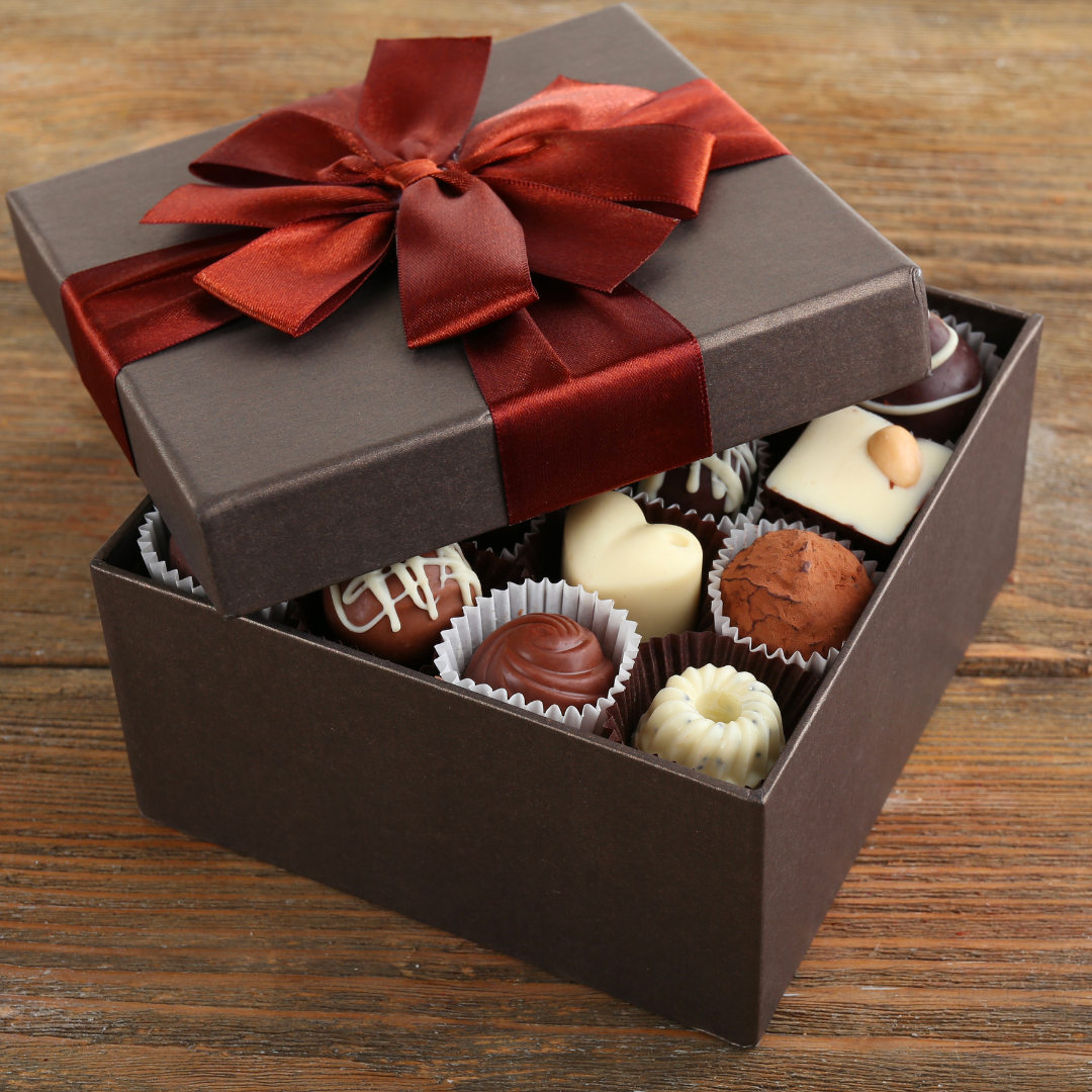 Box of chocolates wrapped in red ribbon